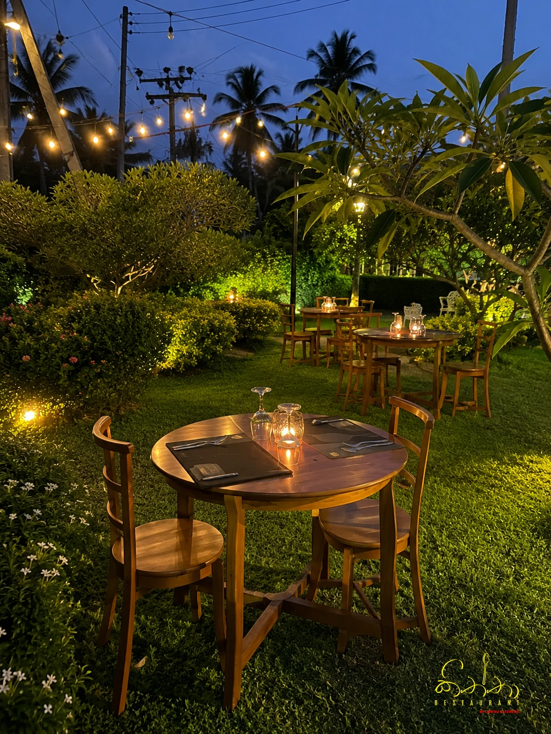 A garden table at Kiththa Ragama loaded with spicy bites and a sharing platter